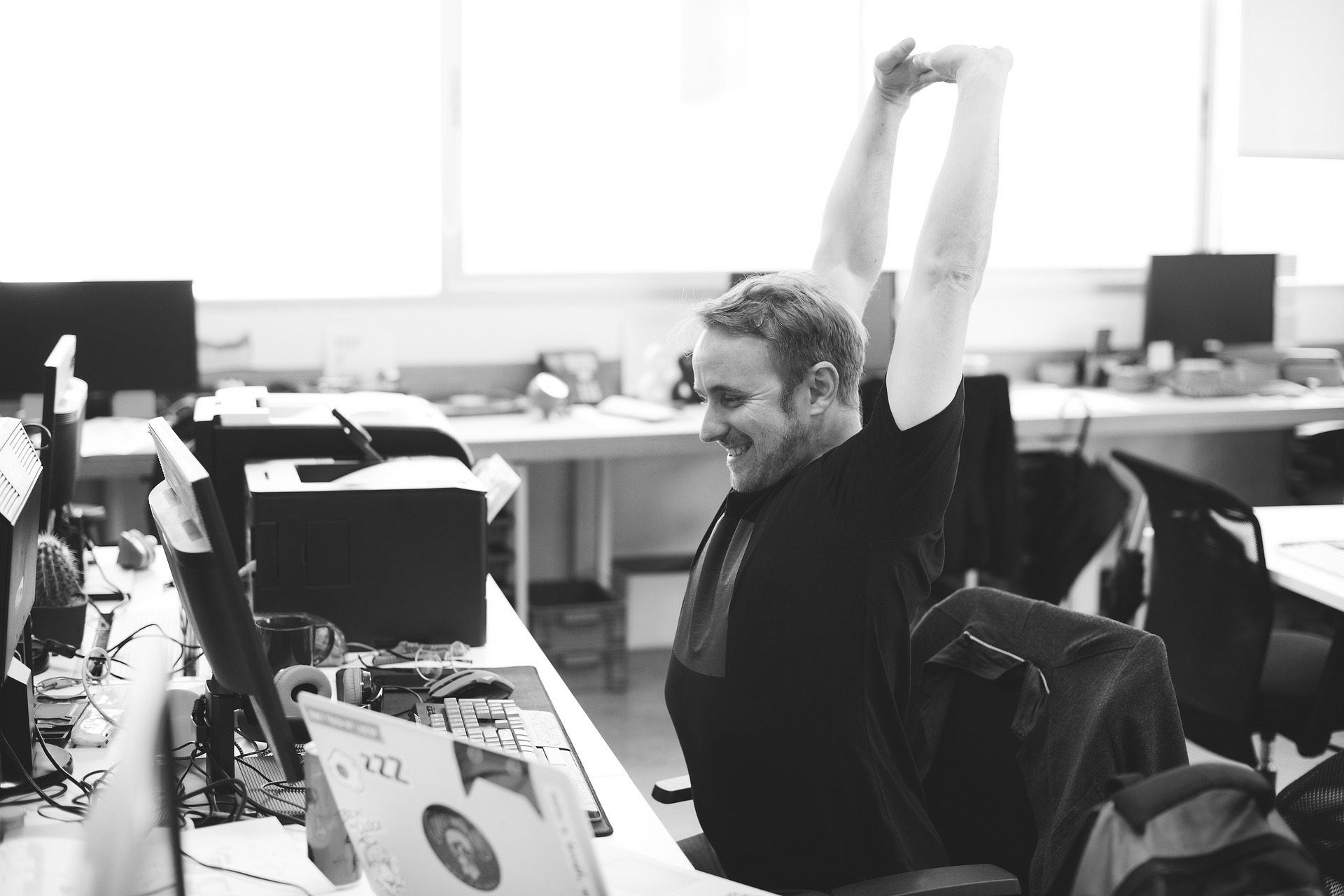 business owner at desk showing accomplishment